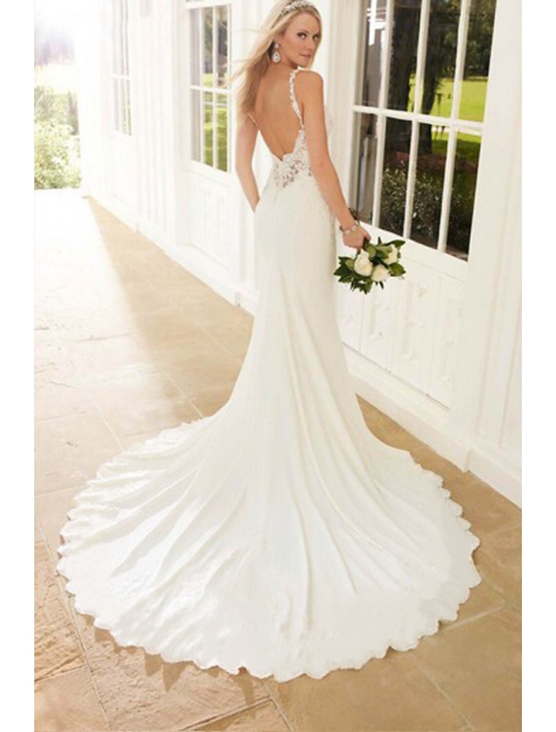 Close-up of delicate lace appliques on a white wedding dress.