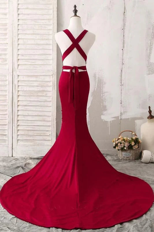 Side profile of woman wearing long mermaid satin dress with V-neck.