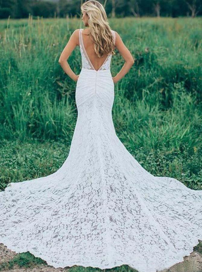 Back view of a ruched backless lace wedding dress with a court train.
