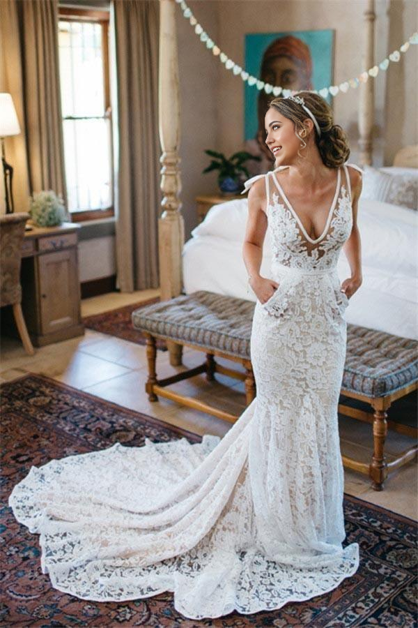 Side view of a mermaid V-neck sleeveless lace wedding gown.
