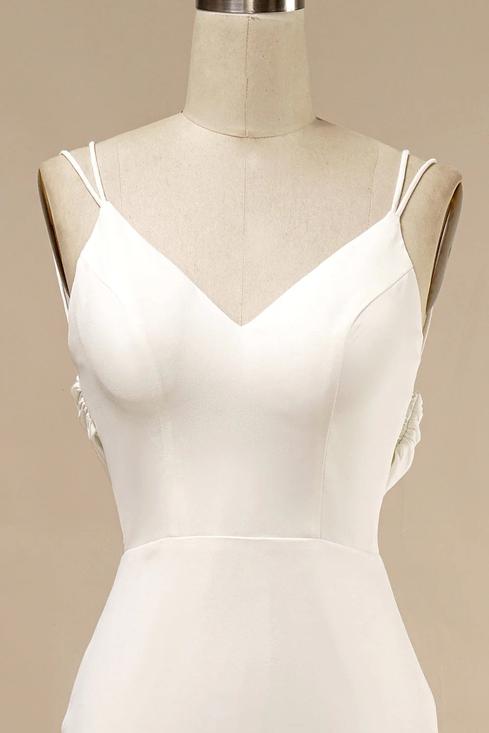Close-up of delicate ruffles on a white wedding dress.
