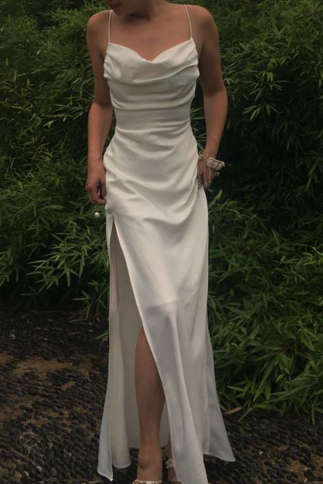 Woman in a mermaid satin prom dress, highlighting the V-neck and elegant silhouette.