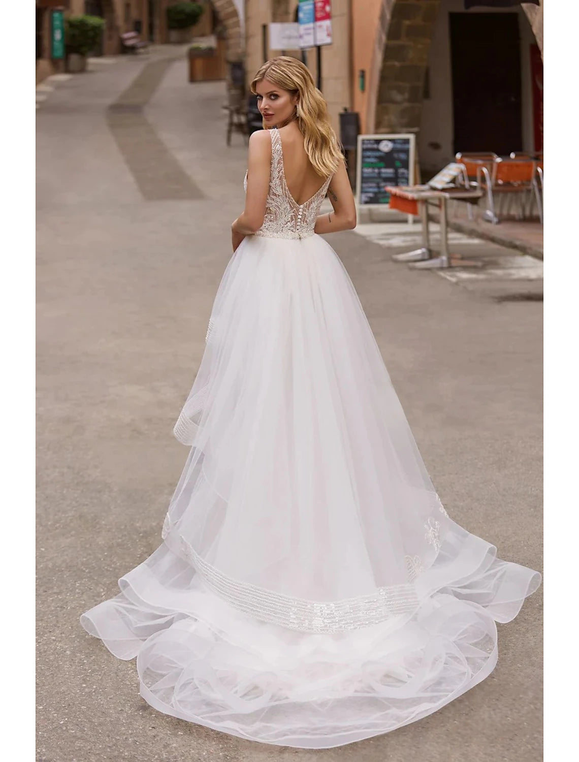 Side view of a mermaid wedding gown, highlighting the court train and delicate appliques.
