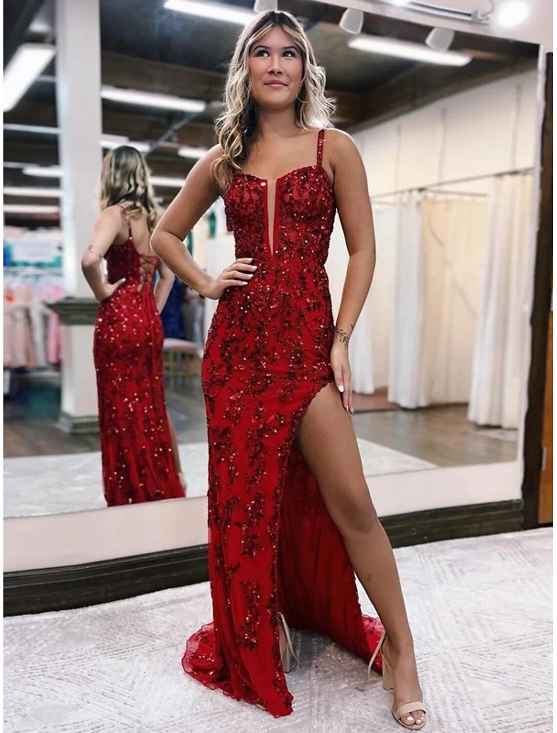 Back view of the mermaid evening gown, highlighting the open back and sweep train.