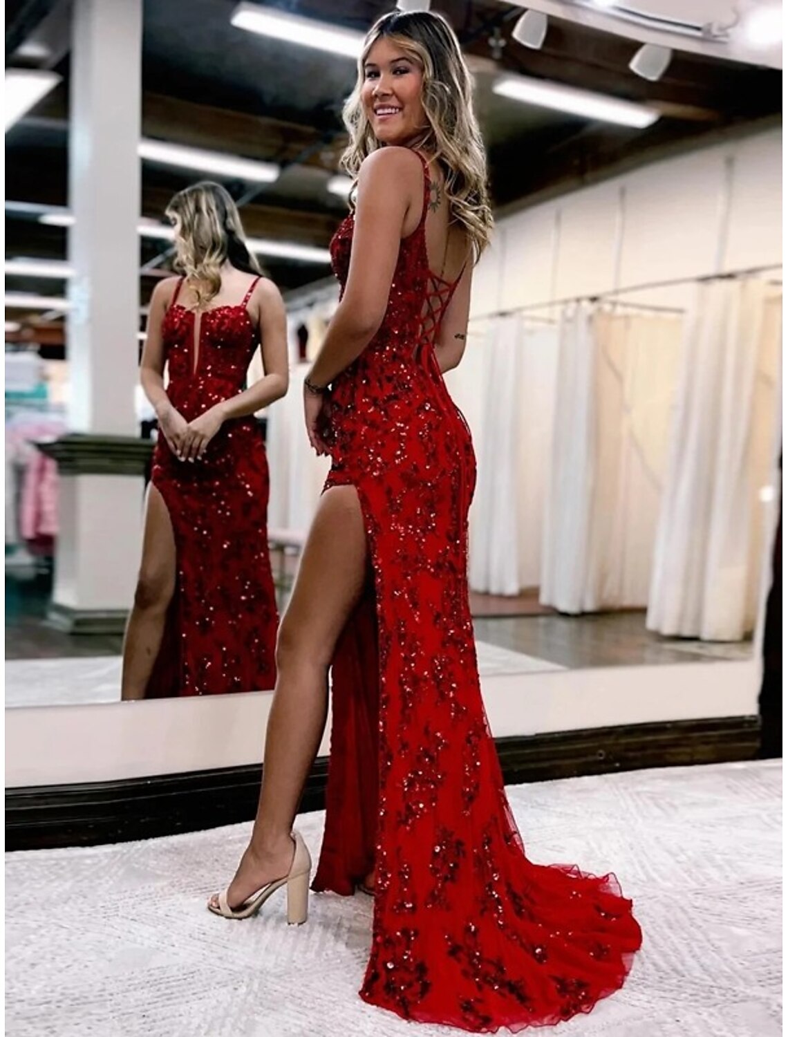 Side view of the mermaid evening gown, showing the elegant silhouette and slit detail.