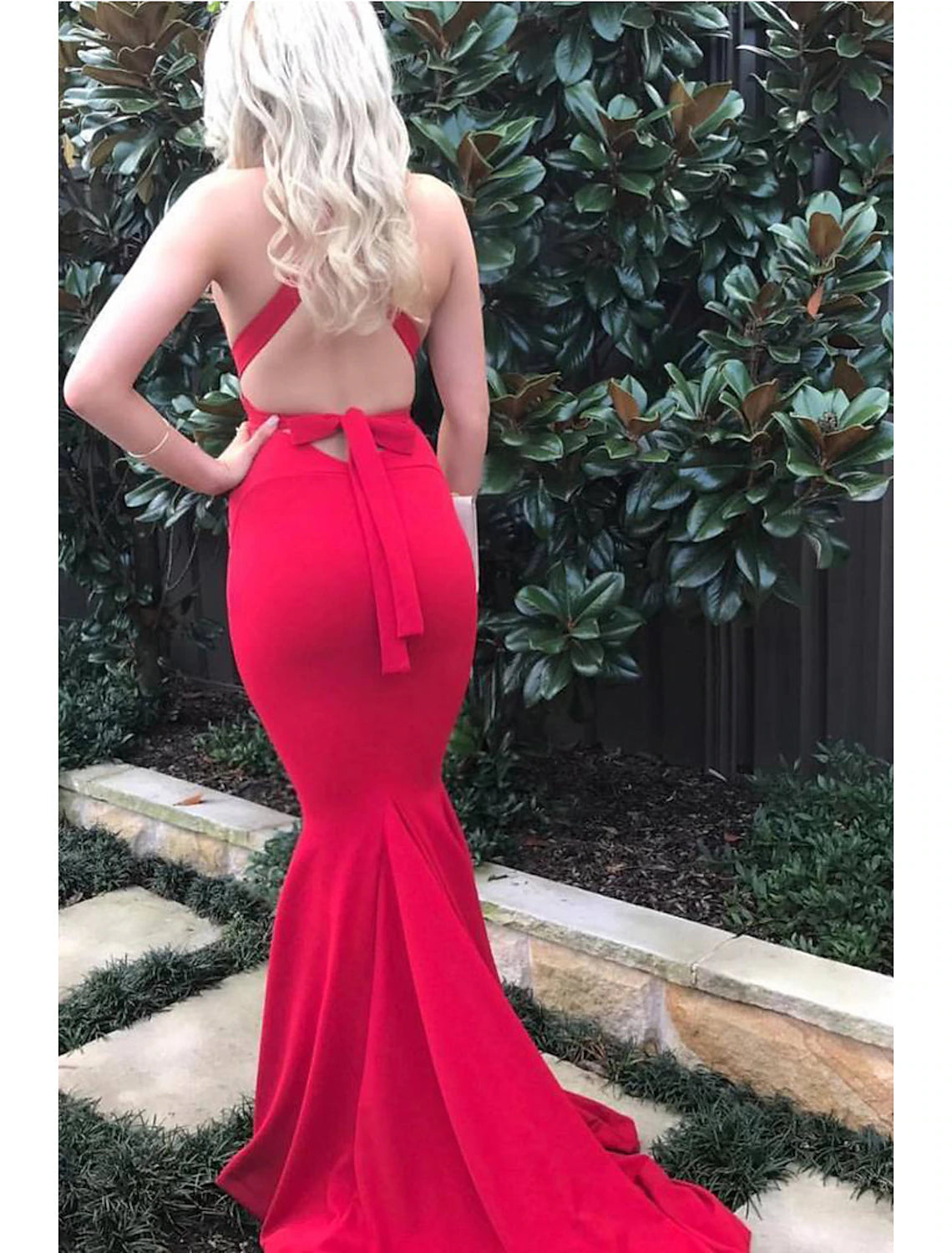 Back view of a formal mermaid evening dress with a long court train.