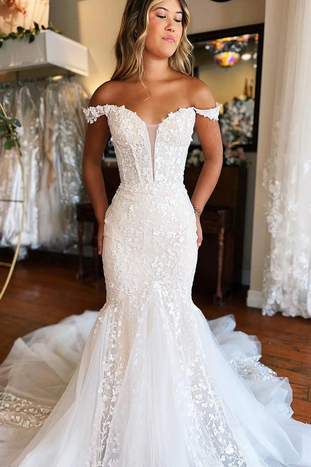 Close-up of the lace appliques on a white mermaid wedding dress.