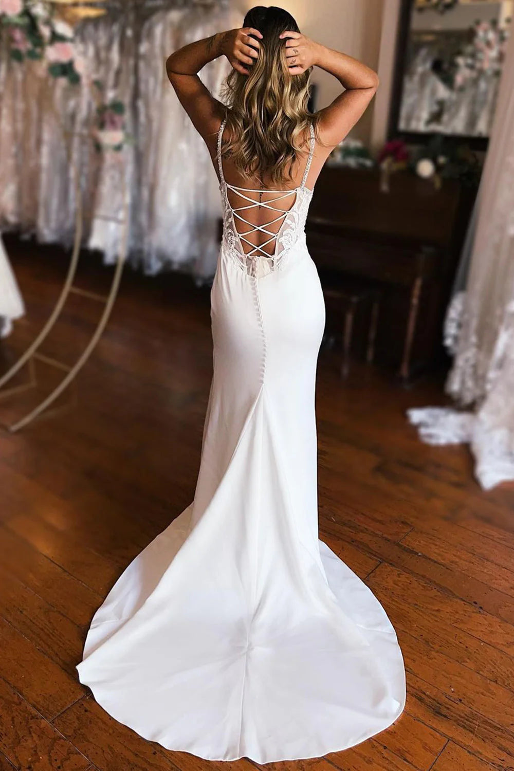 Back view of white mermaid wedding dress showing intricate lace detailing.