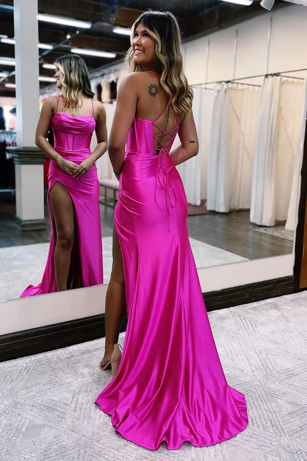 Side view of a woman in a mermaid satin prom dress, showing the V-neck and flowing skirt.