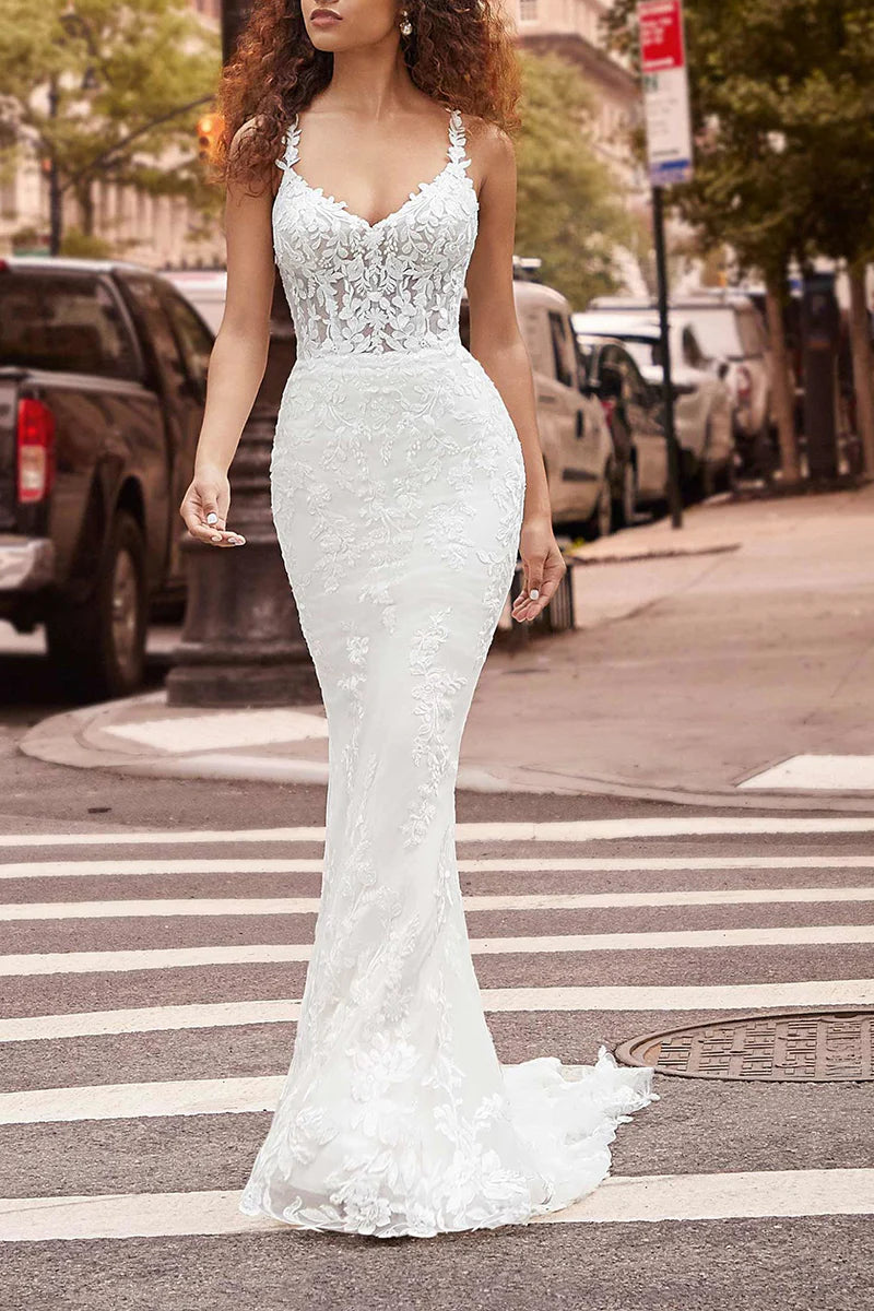 Mermaid V-neck wedding dress with spaghetti straps and lace details.