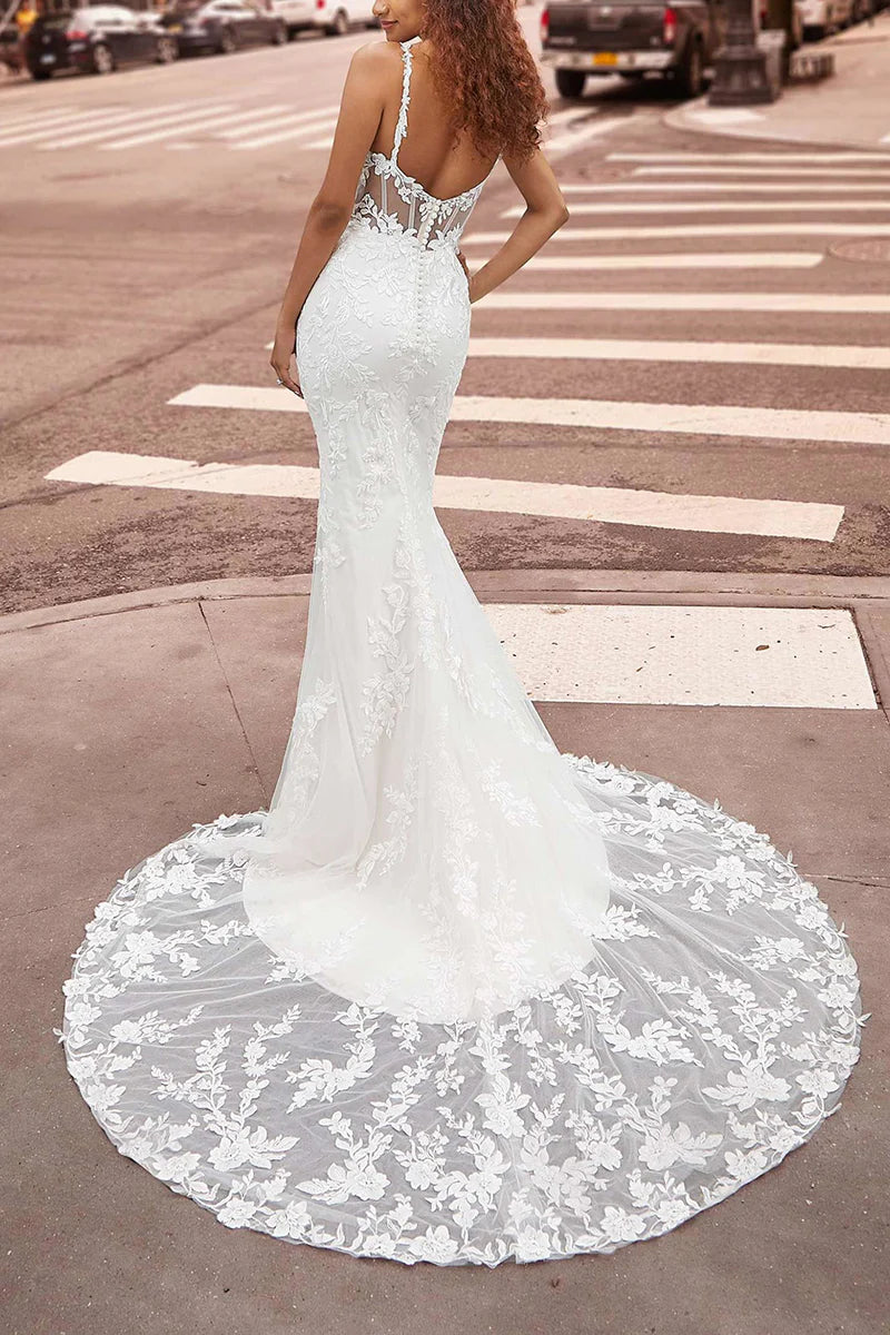 Back view of a mermaid lace wedding dress with spaghetti straps.