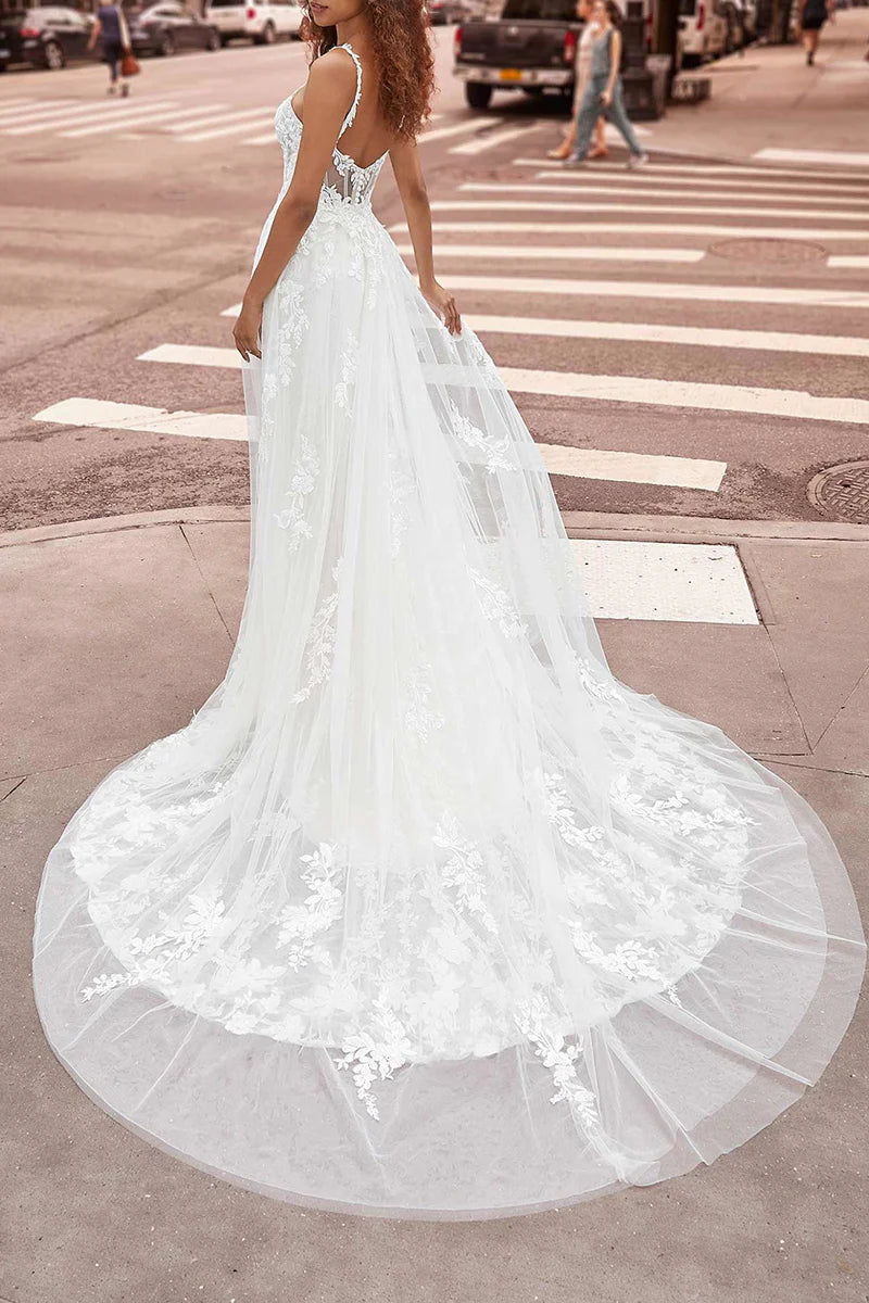 Close-up of lace detailing on a V-neck wedding dress.