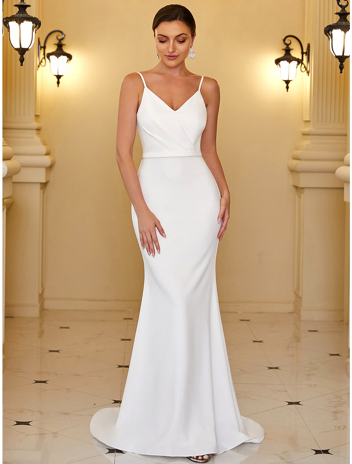 Elegant mermaid trumpet wedding dress with V-neck and spaghetti straps, featuring ruched draping.
