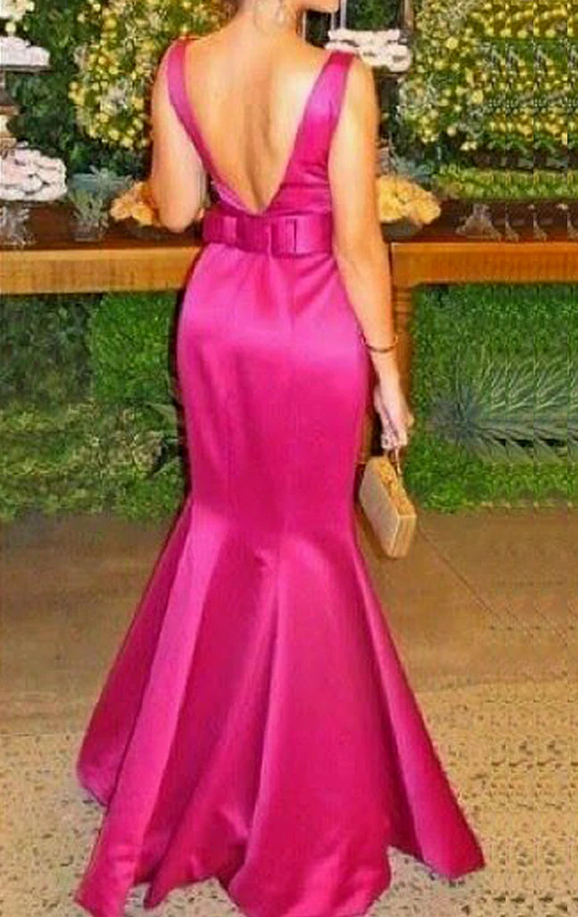 Back view of a woman in a mermaid V-neck satin long prom dress.