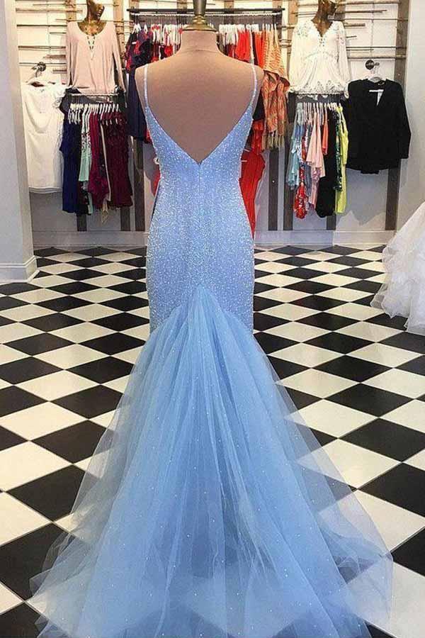 Back view of a woman in a mermaid formal dress, showcasing the backless design and delicate straps.