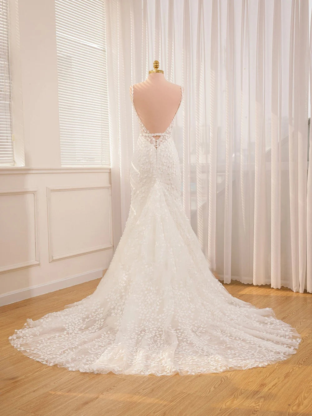 Back view of a mermaid wedding dress with delicate straps and lace details.