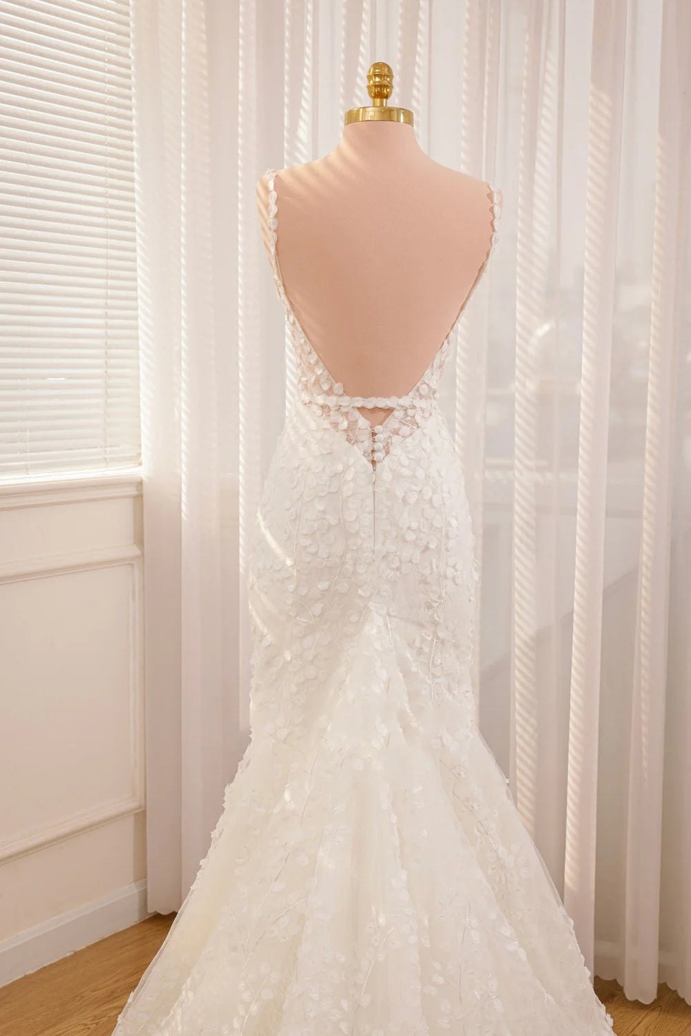 Side view of a bride wearing a mermaid V-neck wedding gown.