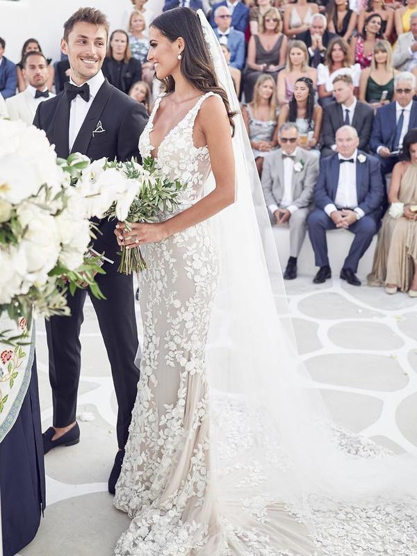 Elegant mermaid wedding dress with lace appliques and V-neck.