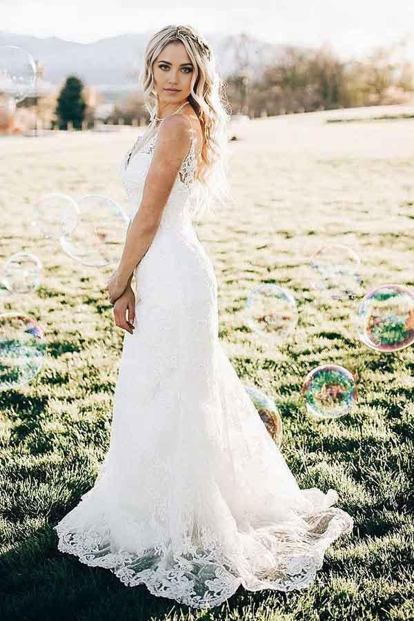 Back view of a mermaid lace wedding gown, showcasing the sweep train.