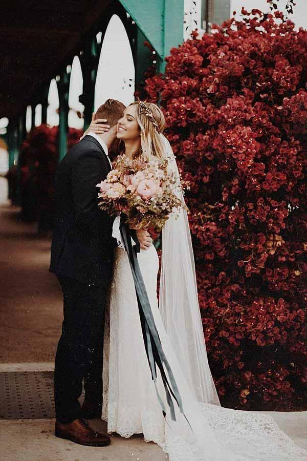 Side profile of a bride wearing a V-neck mermaid wedding dress.
