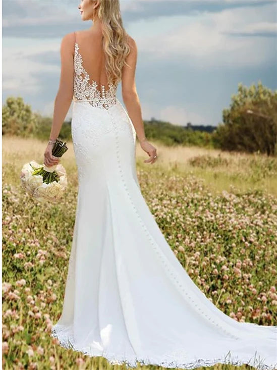 Back view of a mermaid wedding dress, showcasing the elegant court train and delicate appliques on the skirt.