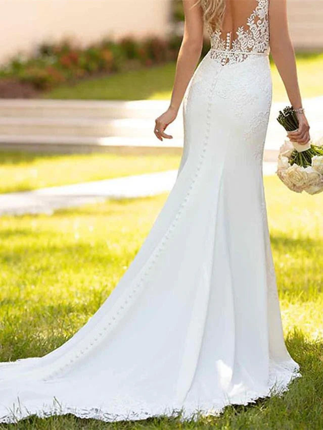 Close-up of the V-neckline and intricate floral appliques on the bodice of the mermaid wedding dress.