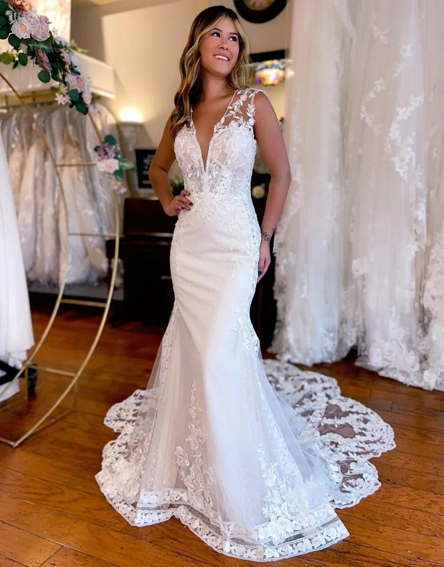 Elegant Mermaid V-Neck wedding dress with appliques and chapel train.