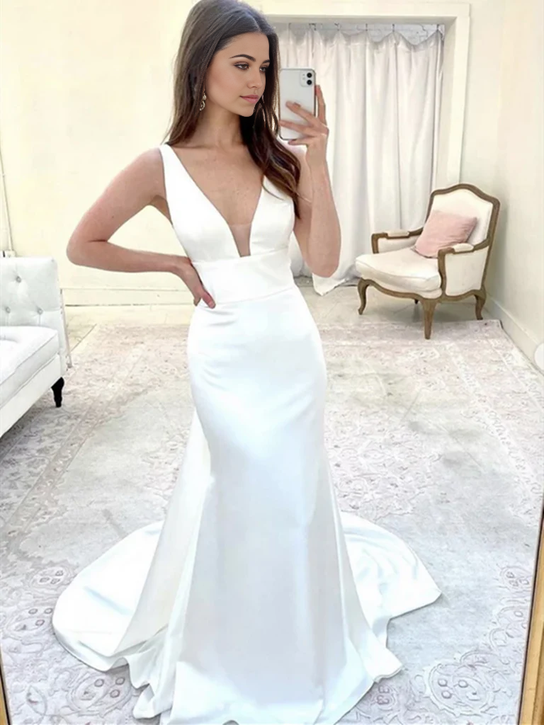 Model wearing a white mermaid V-neck long formal dress.