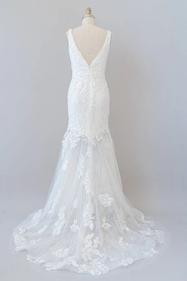 Back view of a long mermaid wedding dress with lace details.