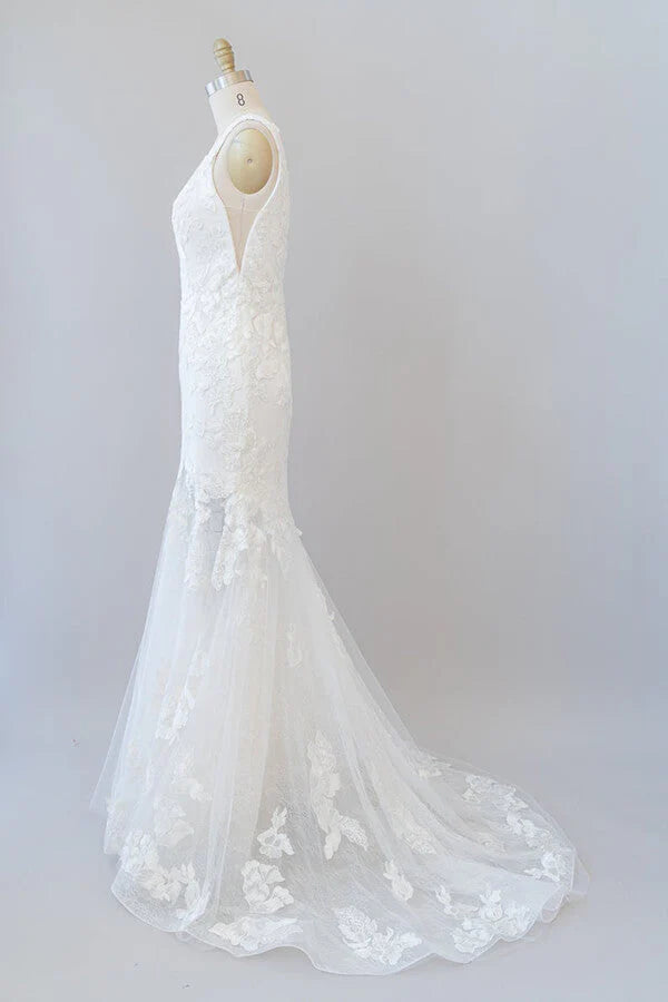 Side view of an elegant V-neck bridal gown with flowing tulle.