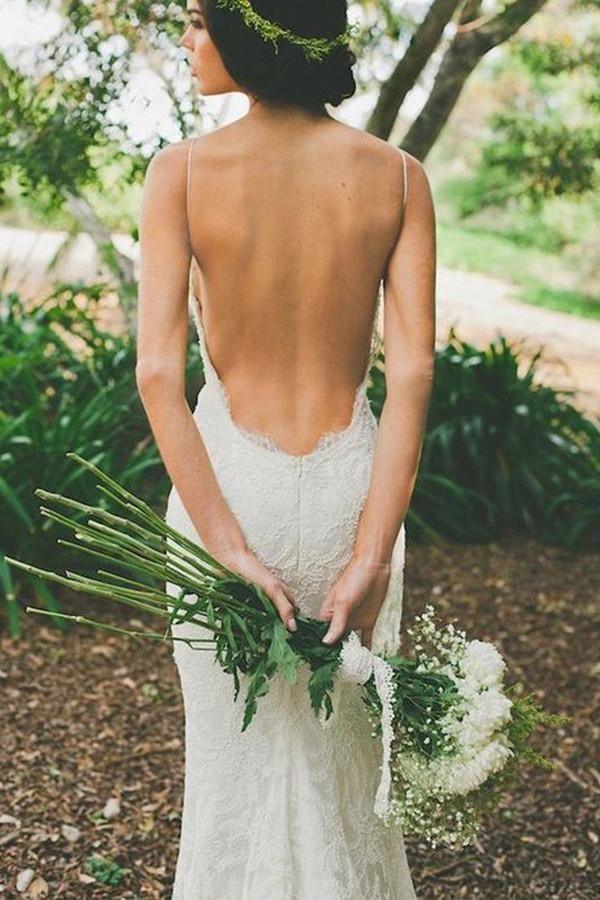 Back view of a white mermaid wedding dress with a sweep train.