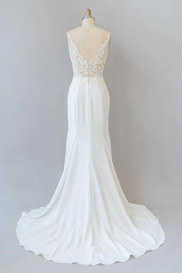 Back view of a mermaid wedding dress showing lace and backless design.