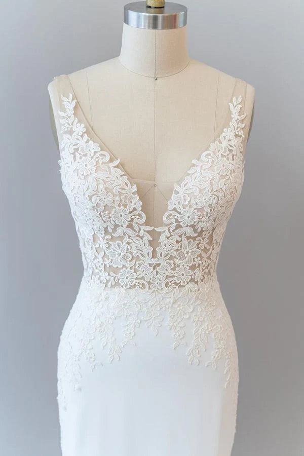 Side profile of a bride wearing a long mermaid wedding gown.