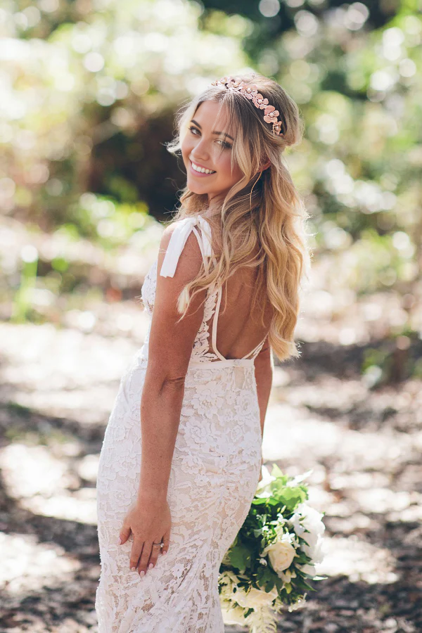 Elegant mermaid V-neck lace wedding dress with a sweep train, front view.