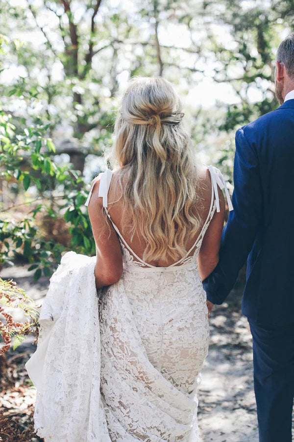 Back view of a mermaid V-neck lace wedding dress, showcasing the sweep train.