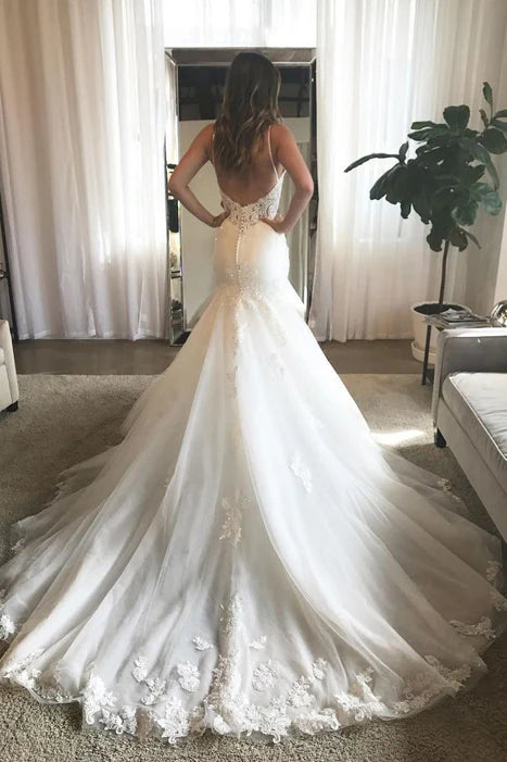 Back view of the mermaid wedding dress showcasing open back and lace details.