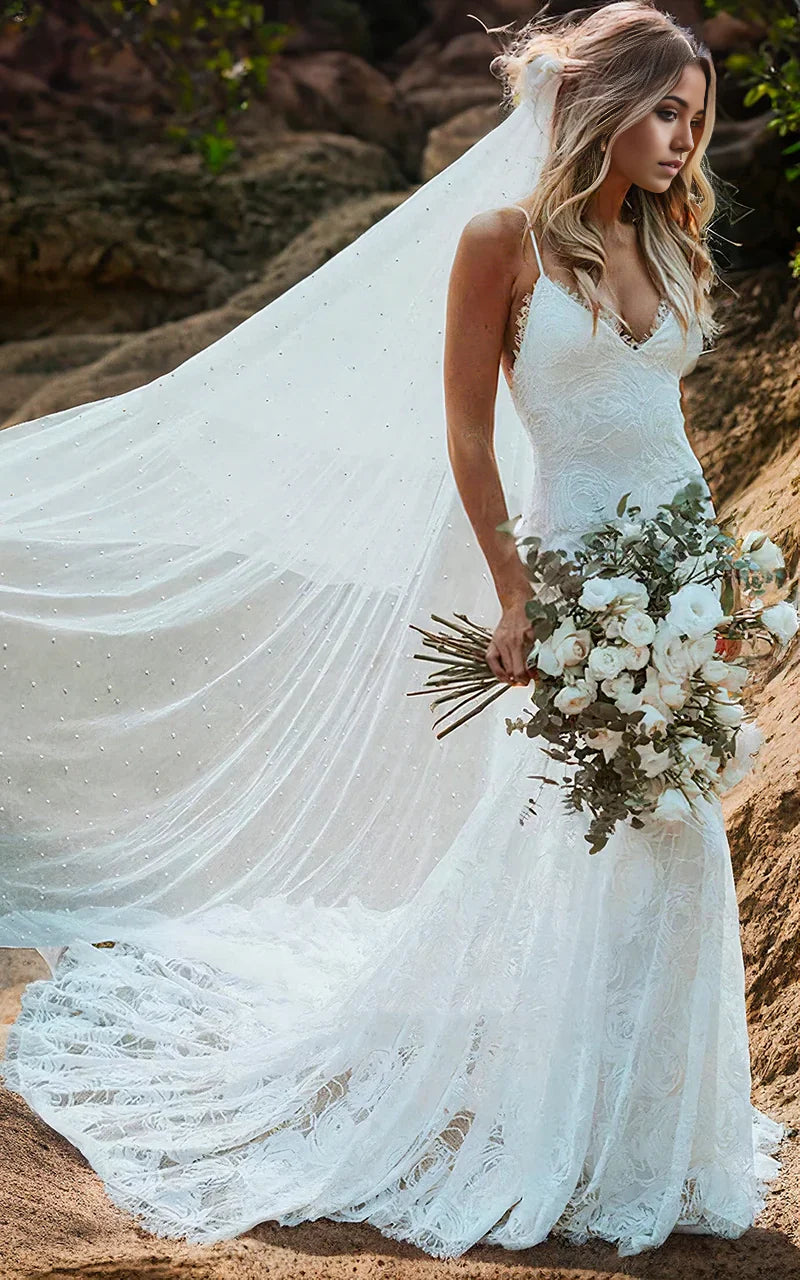 Front view of elegant mermaid V-neck wedding dress with spaghetti straps and vintage lace.
