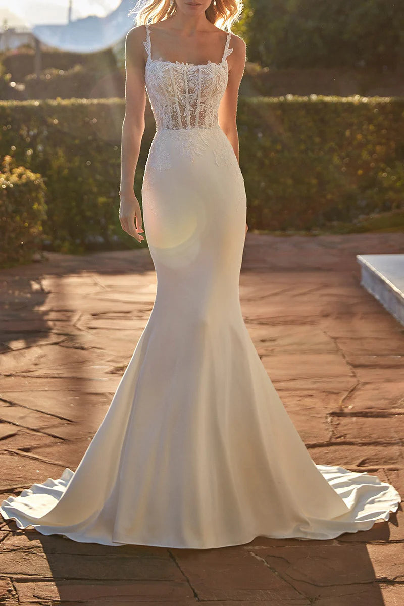 Elegant mermaid wedding dress with scoop neckline and lace appliques, front view.