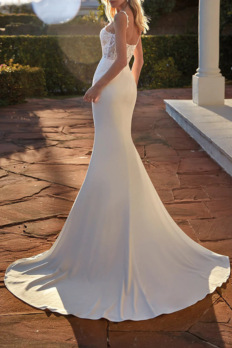 Back view of a mermaid wedding dress featuring a scoop neckline and lace details.