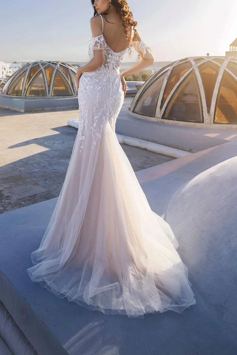 Back view of mermaid wedding gown with delicate lace details.
