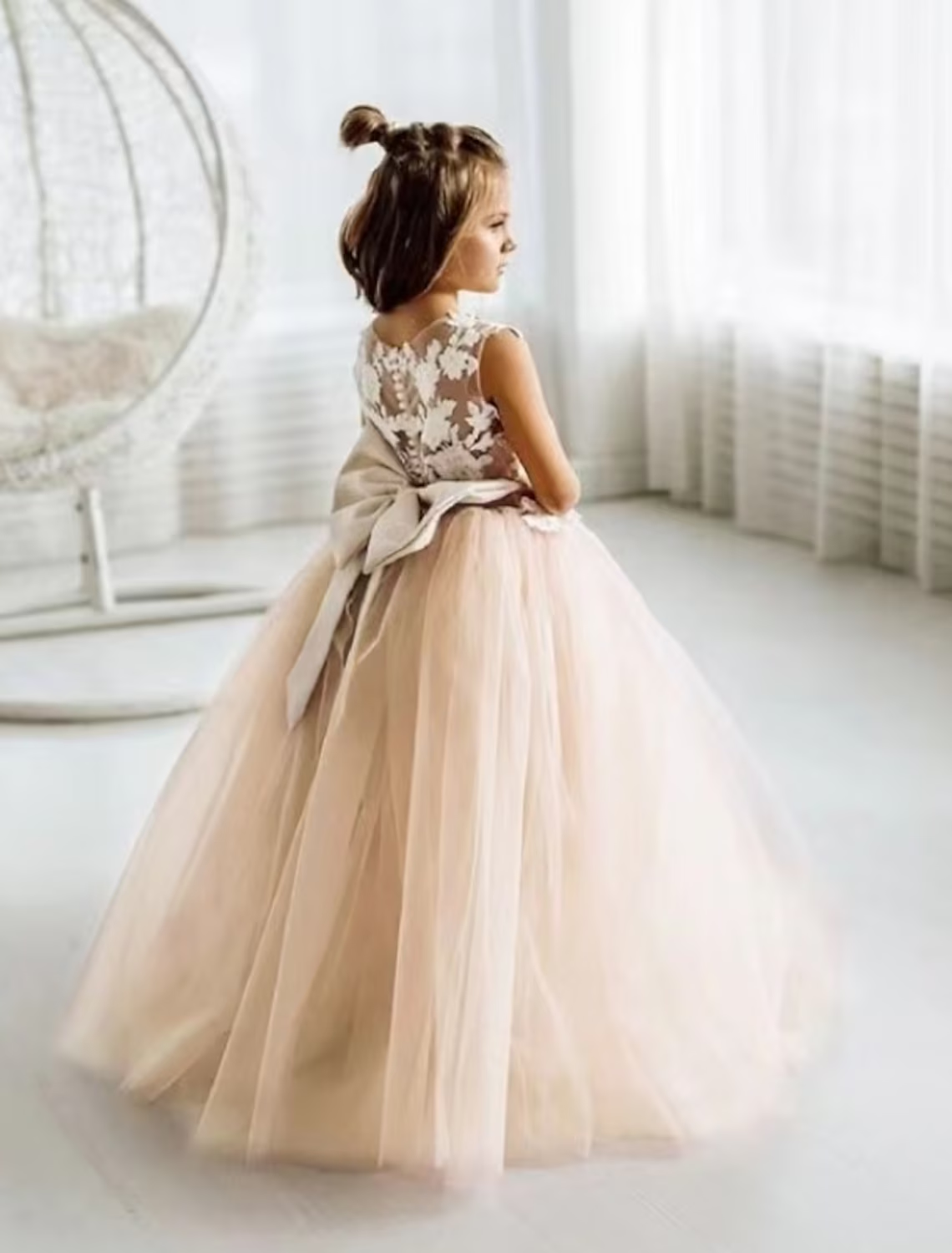 Girl wearing a champagne sleeveless mesh princess party dress.
