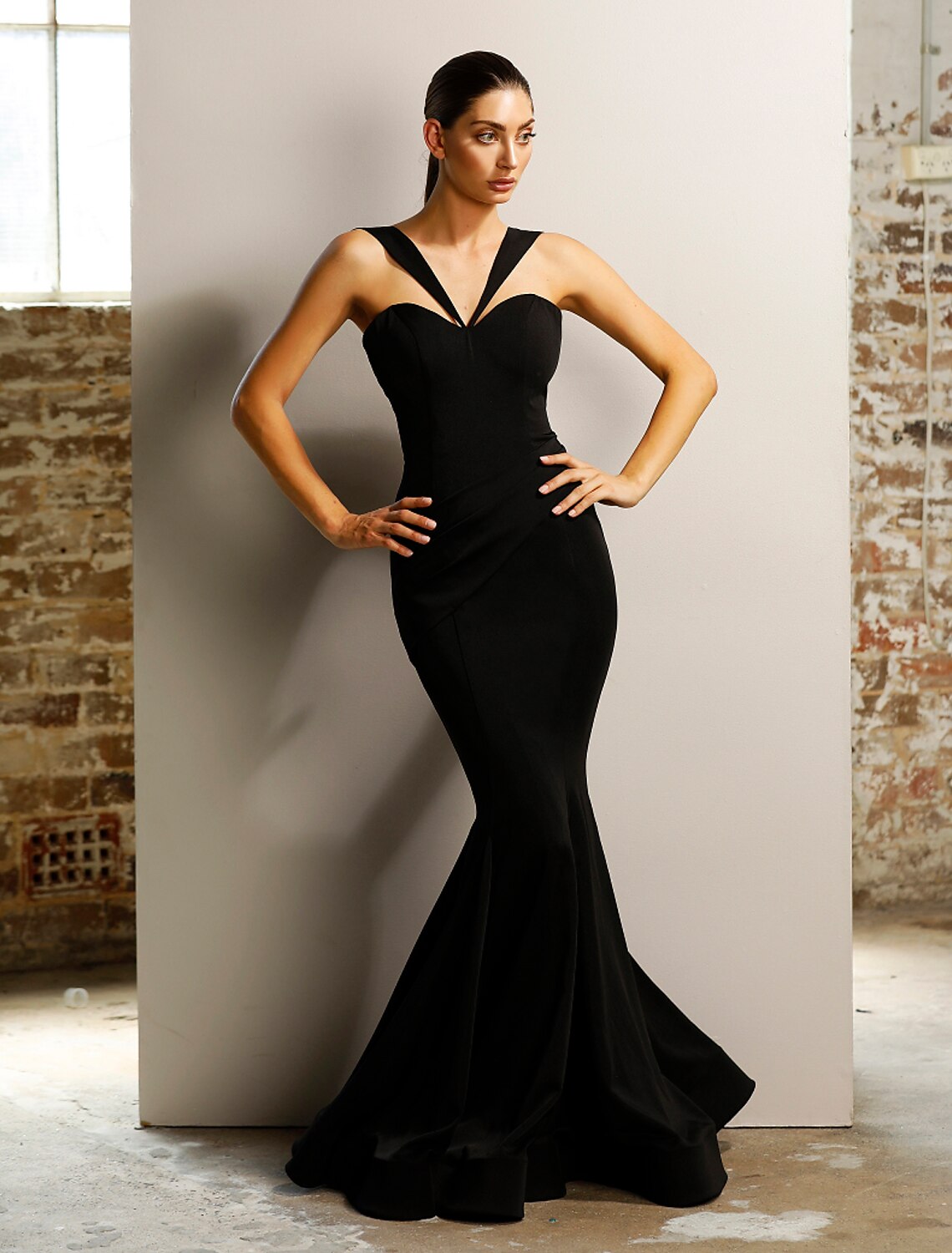 Side profile of the stretch satin mermaid trumpet dress.