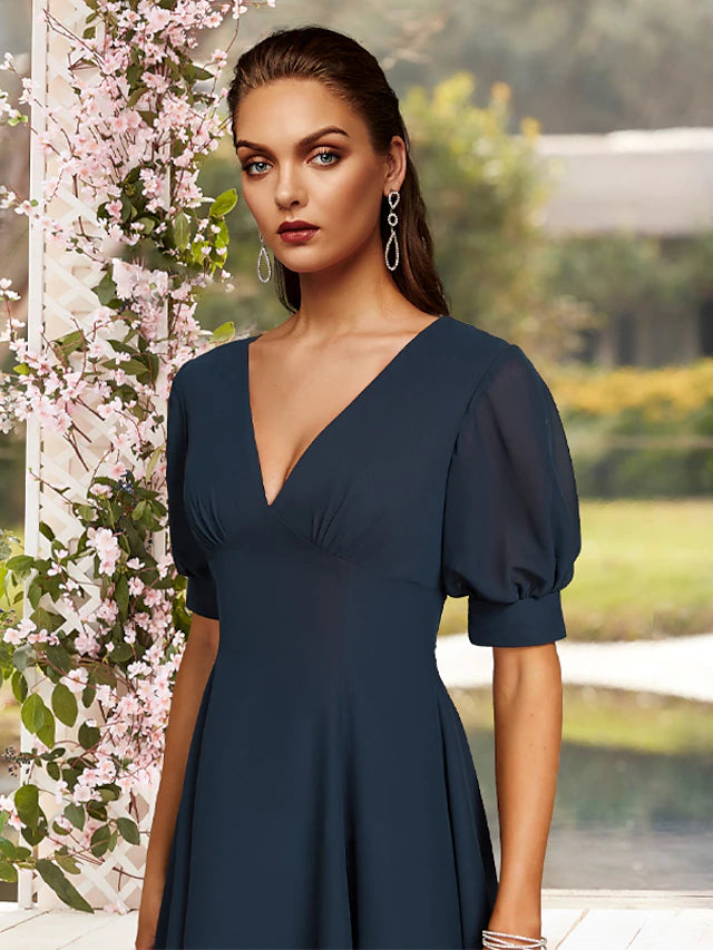 Back view of the tea-length satin Mother of the Bride dress with ruching detail.