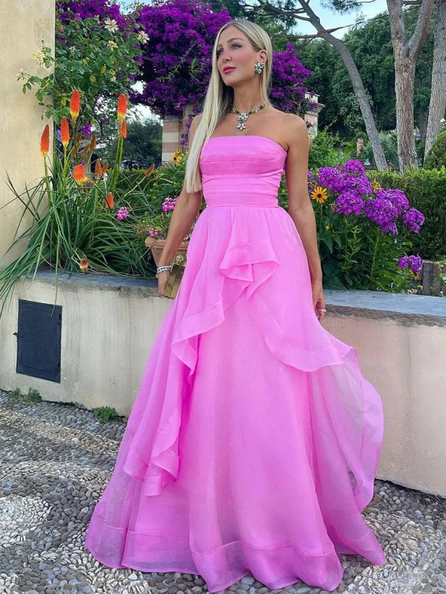 Model posing in a flowing strapless formal dress.