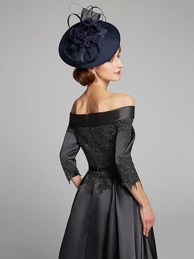 Close-up of the navy satin and lace fabric detail on the Mother of the Bride dress.