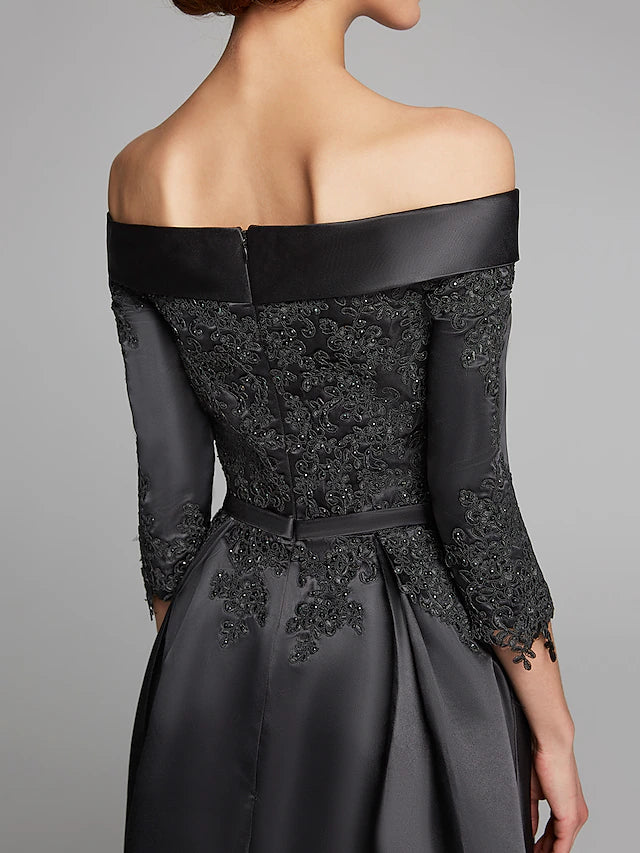 Back view of the navy A-line off-shoulder Mother of the Bride dress with a lace sash.