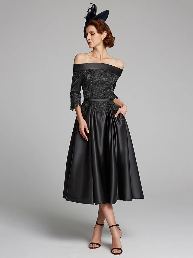 Woman smiling while wearing the elegant navy Mother of the Bride dress.