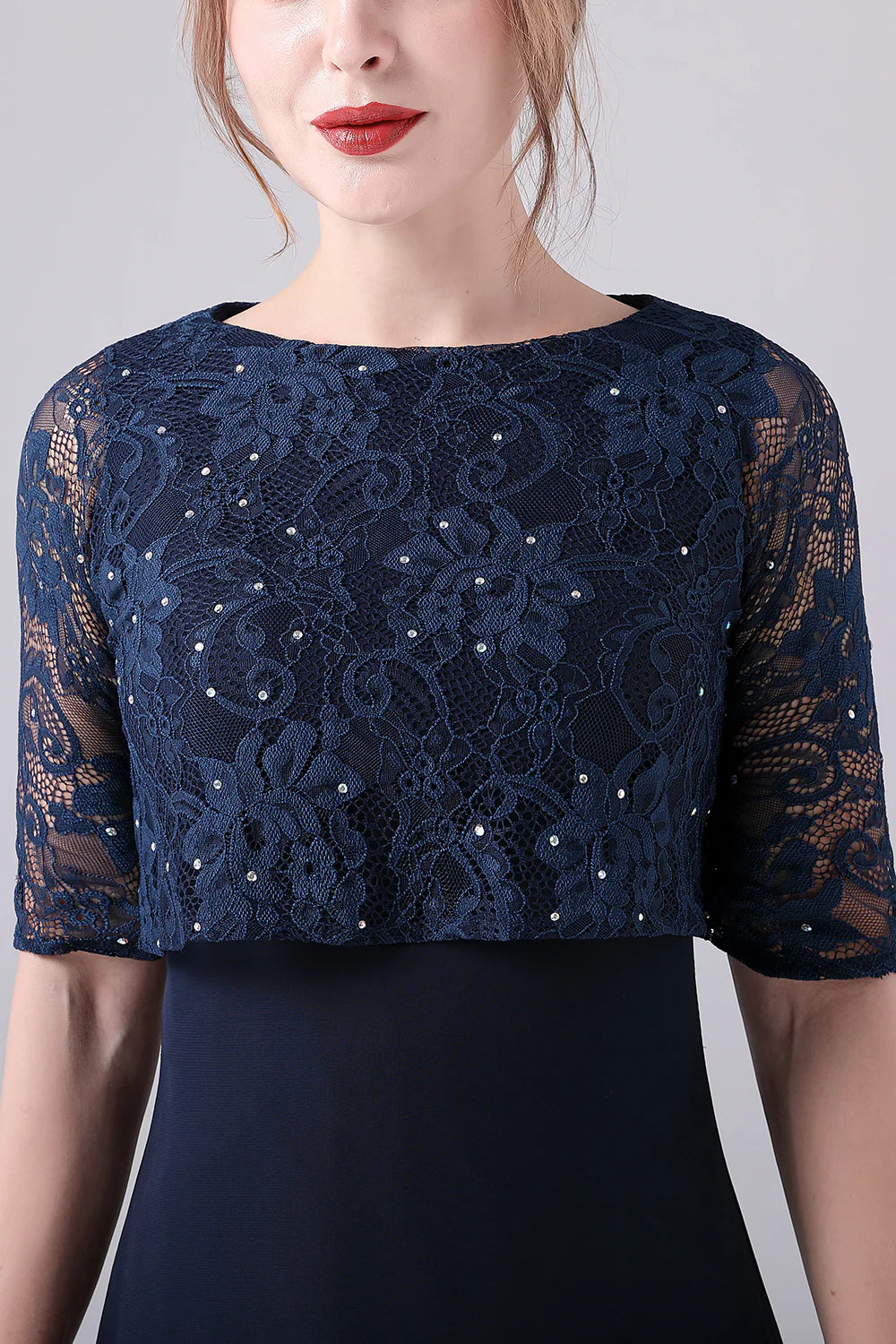 Close-up of the V-neckline and short sleeves on the navy dress.