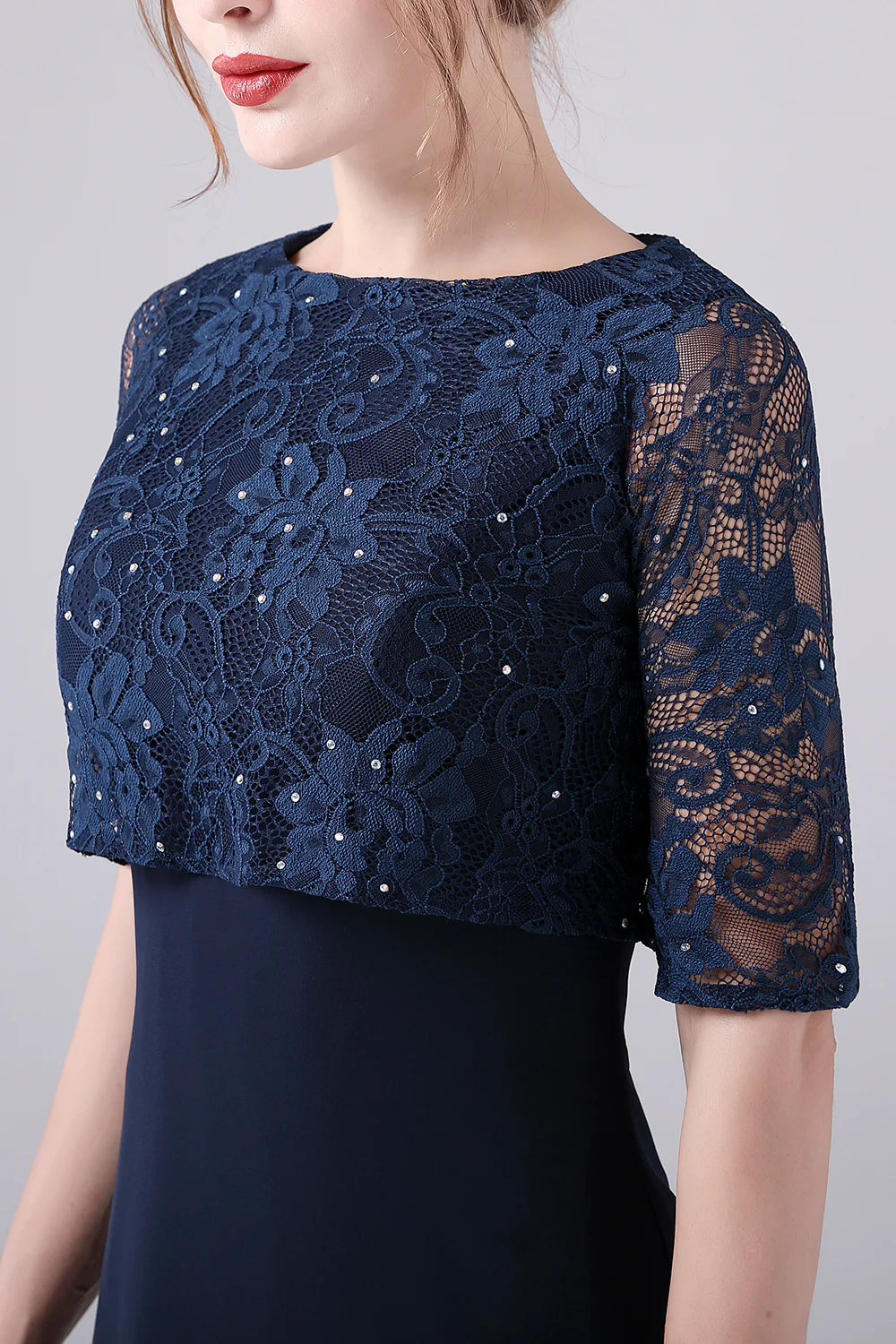 Detail of the flowing chiffon fabric on the navy dress.