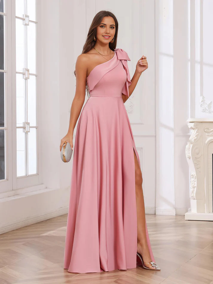 Woman wearing a navy blue A-line one-shoulder satin prom dress.